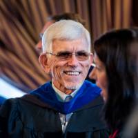 Man smiles while waiting in line for awards